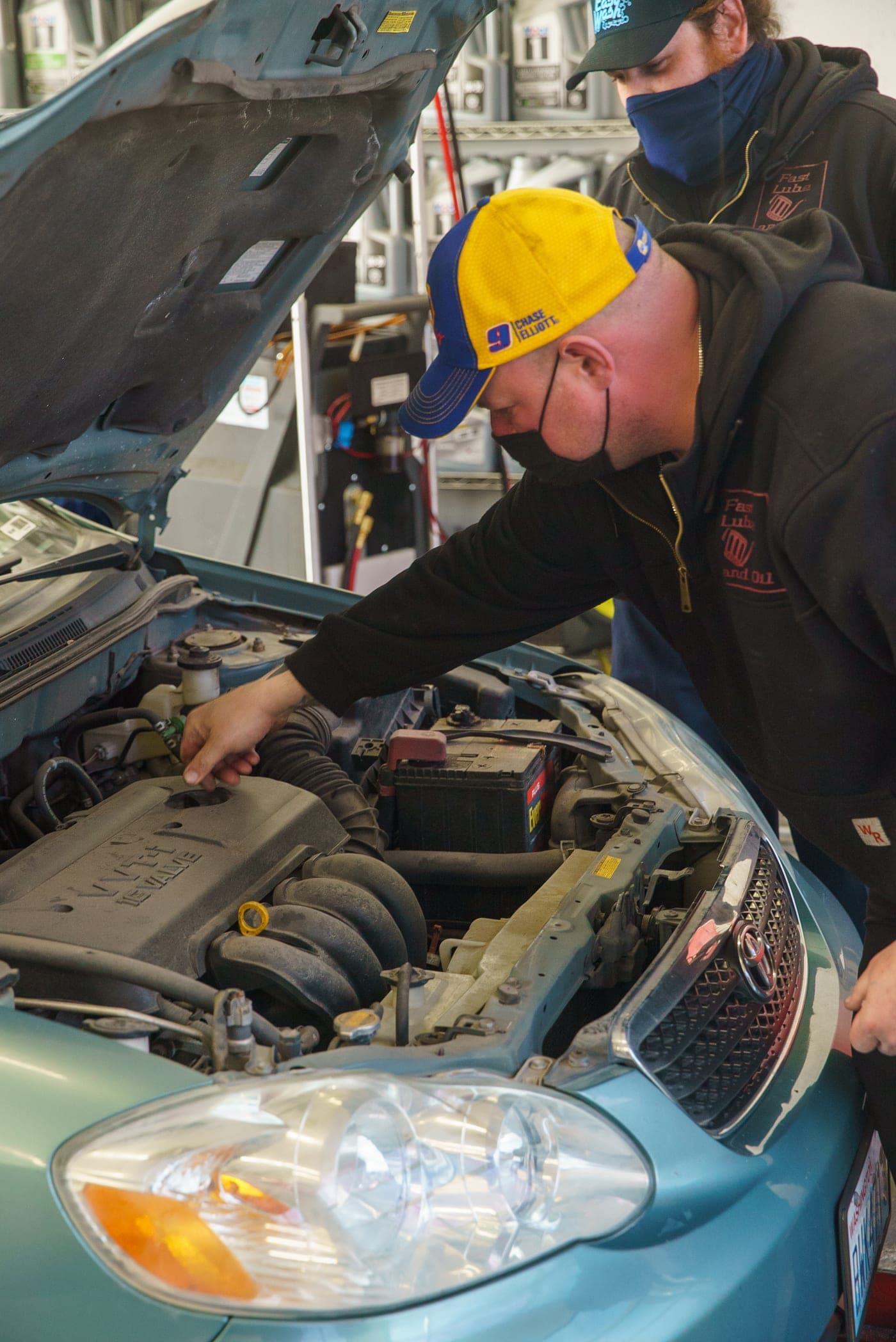 A Fast Lube & Oil technician performing an oil change in Astoria