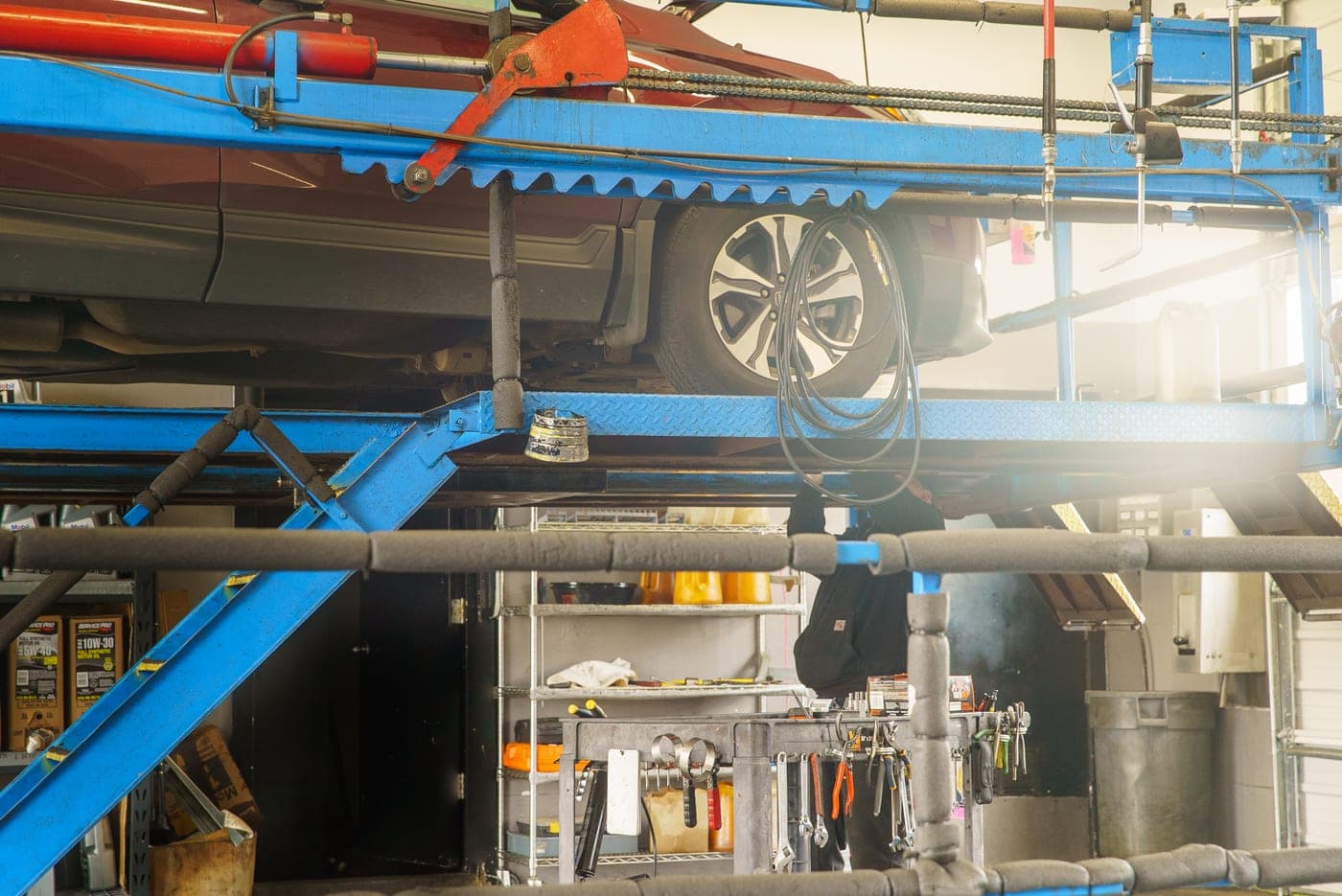 A vehicle raised on the lift for a full service