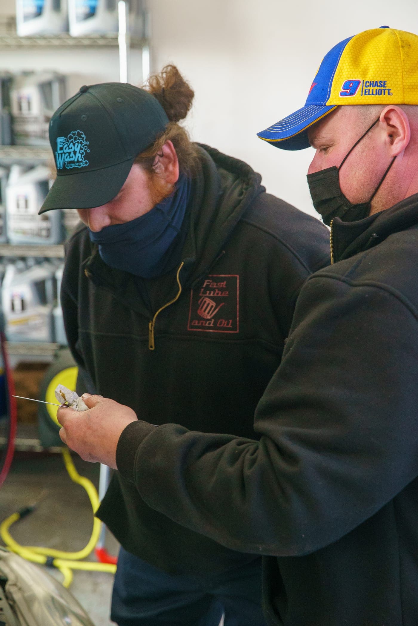 A Fast Lube & Oil technician performing an oil change